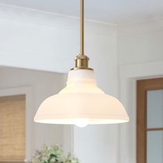 a white light hanging over a kitchen counter