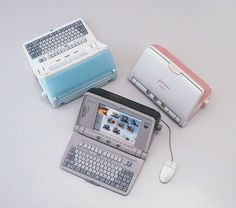 there are three different types of electronic devices on the table, one with a keyboard and mouse