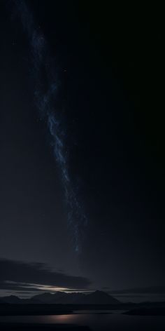 the night sky is filled with stars and some dark clouds, as seen from an island