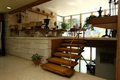 the stairs are made of wood and have wooden treads on them, leading up to an open kitchen area