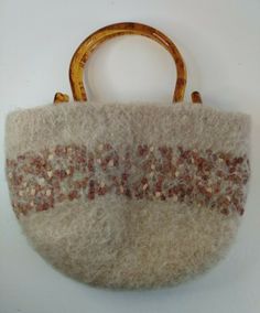 a handbag made out of wool and wooden handles