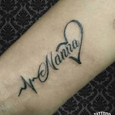 a tattoo with the word mama written in cursive writing on it's arm