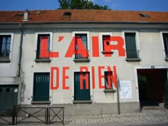 an old building with red lettering on it