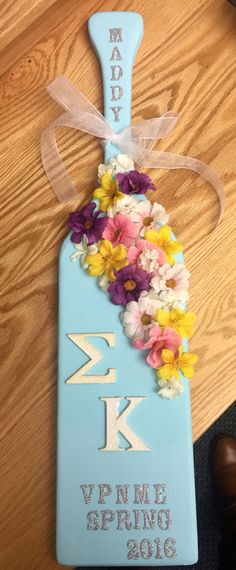 a wooden sign with flowers on it that says happy valentine's day and is decorated with ribbon