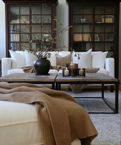 a living room filled with furniture and candles