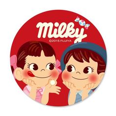 a couple of kids that are standing in front of a red button with the words milky on it