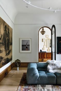 a living room filled with furniture and paintings