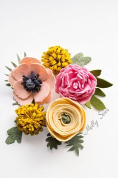 three different colored flowers with leaves on them