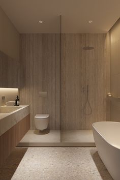 a bathroom with a tub, toilet and sink in it's shower stall area