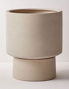 a white vase sitting on top of a table