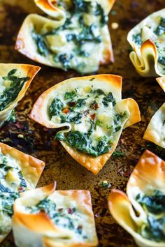 spinach and cheese wonton cups on a baking sheet