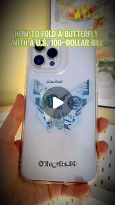 someone is holding up their phone case to show how it has been made with dollar bills