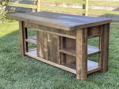 a wooden table sitting on top of a lush green field