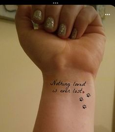 a woman's arm with a tattoo saying nothing loved is ever lost