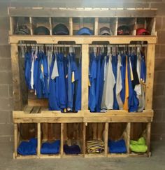 an old wooden coat rack filled with baseball uniforms