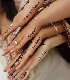 two brides hands with henna tattoos on their fingers and the words marriage written on them