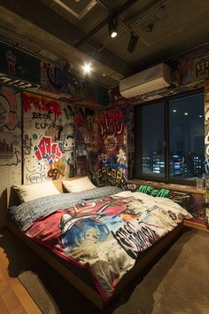 a bedroom with graffiti on the walls and a bed in it's center area