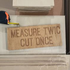 a sign that says measure twoc cut once on the front of a cabinet door