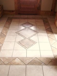 a tiled floor with a door and window in the background