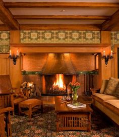 a living room filled with furniture and a fire place in the middle of a room