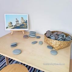 a table with rocks on it and a basket full of stones in front of it