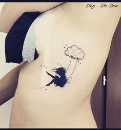 a woman with a tattoo on her stomach flying through the air while holding onto a kite