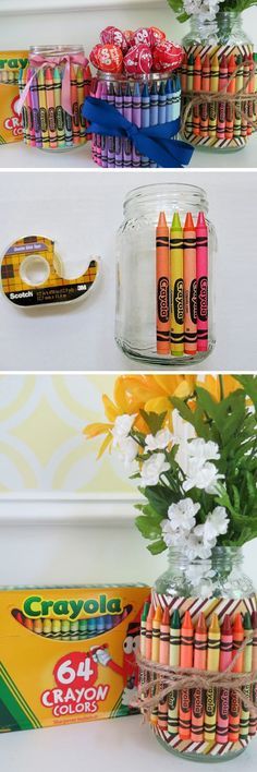 crayons are lined up on the shelf next to a vase filled with flowers