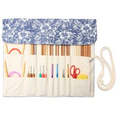 the organizer is organized with sewing tools and other crafting supplies, including knitting needles