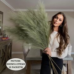 a woman holding a bunch of green plants in her hands with the caption picture shows 6 stems 12 packets