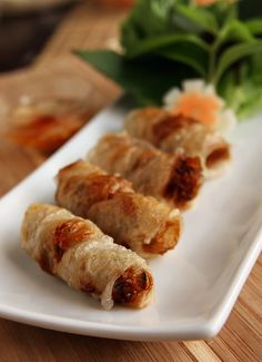 some food is on a white plate and ready to be eaten with chopsticks