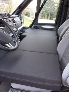 the interior of a truck with grey seats