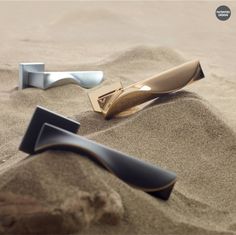 two metal objects laying in the sand near each other