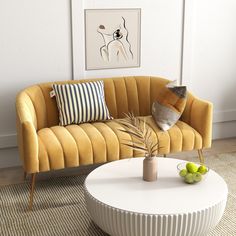 a living room with a couch, coffee table and pictures on the wall behind it