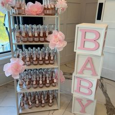 baby shower products displayed on shelves with pink flowers