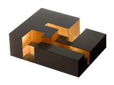 an abstract sculpture made out of wood and black material with the letter e on it