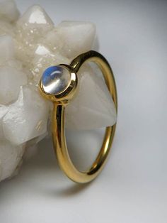 18K yellow gold ring with natural Adularia Moonstone round cabochon moonstone origin - Sri Lanka moonstone measurements - 0.12 х 0.16 х 0.16 in / 3 х 4 х 4 mm stone weight - 0.34 carats ring weight - 2.67 grams ring size - 7 US ref No 3018 Worldwide shipping from Berlin, Germany Feel free to contact us with any questions or for additional pictures or videos. We ship our jewelry worldwide with tracking, fully insured. To ensure that everything arrives securely and unharmed at the recipient, we on Gold Moonstone Round Jewelry, Gold Moonstone Ring Fine Jewelry With Birthstone, Gold Stackable Moonstone Ring, Round Shape, 14k Gold Celestial Opal Ring, 14k Gold Fine Jewelry Moonstone Cabochon Ring, Fine Jewelry 14k Gold Cabochon Moonstone Ring, Gold Moonstone Ring In 14k Gold, Gold Stackable Moonstone Gemstone Rings, Gold Moonstone Ring With Bezel Setting For Gift