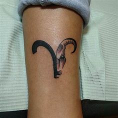 a woman with a goat head tattoo on her leg