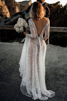 the back of a bride's dress with sequins on it is shown