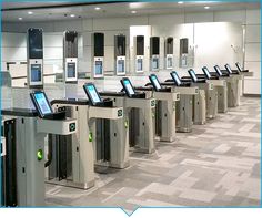 there are many electronic turnsets in the airport terminal with their screens on each side