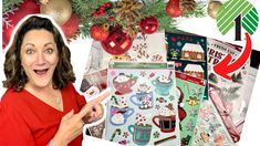 a woman pointing at christmas stickers in front of a pile of holiday themed items