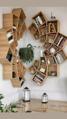 a living room with bookshelves on the wall and a potted plant in the corner