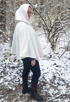 This short white cloak is delightfully soft and comfortable. It's long enough to reach the back of the hand, keeping you warm but keeping your hands available when needed. It has a full hood and closes with a matching cloth frog clasp. This cloak is great for a costume piece or a cozy jacket, great for Spring, Fall, and looks lovely over casual clothes or keeping you warm at a winter wedding. Your cloak will measure about 30 inches in length. This listing is in cream white, but other colors are Hood Wedding, White Cloak, Cape With Hood, Short Blanc, Cozy Jacket, Wedding Cape, White Fleece, Casual Clothes, Full Circle