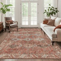 a living room filled with furniture and a large rug