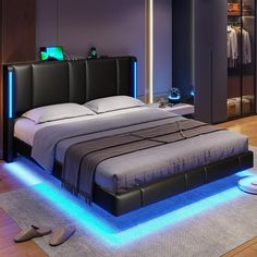 a modern bedroom with blue lighting on the bed