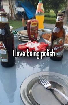 i love being polish on the table in front of some beer bottles and plates with food