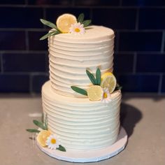 a white cake with lemons and flowers on it