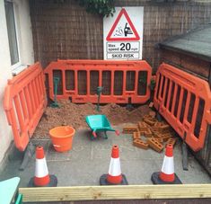 there are construction barriers around the yard area for children to play in and do something