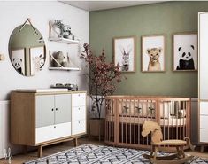 a baby's room with green walls and pictures on the wall, including a crib