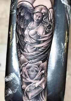 an angel tattoo on the arm with roses and wings around it, in black and white