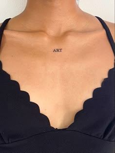 a woman with a small tattoo on her chest